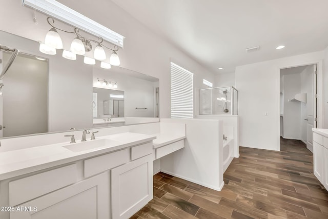 9017 E June Cir, Mesa, AZ 85207 - bathroom featuring a stall shower, vanity, wood finished floors, a garden tub, and recessed lighting