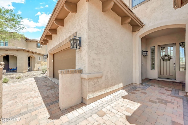 9017 E June Cir, Mesa, AZ 85207 - view of exterior entry with stucco siding and a garage