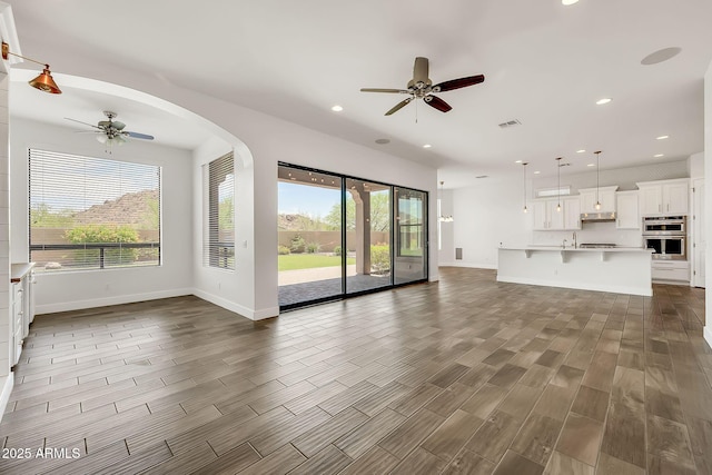 9017 E June Cir, Mesa, AZ 85207 - unfurnished living room with a ceiling fan, plenty of natural light, dark wood-style flooring, and recessed lighting