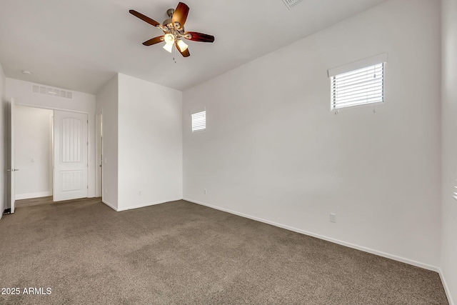 9017 E June Cir, Mesa, AZ 85207 - unfurnished room featuring healthy amount of natural light, dark colored carpet, ceiling fan, and baseboards