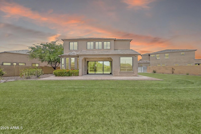 9017 E June Cir, Mesa, AZ 85207 - back of property at dusk with a patio, stucco siding, and a tile roof