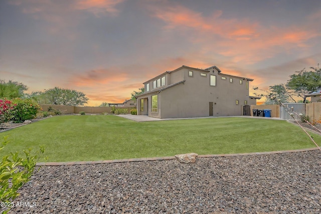 9017 E June Cir, Mesa, AZ 85207 - back of house at dusk with stucco siding, a gate, and a patio area