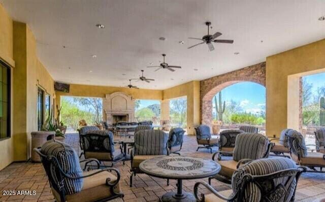 9017 E June Cir, Mesa, AZ 85207 - view of patio / terrace featuring an outdoor living space with a fireplace, outdoor dining area, and a ceiling fan