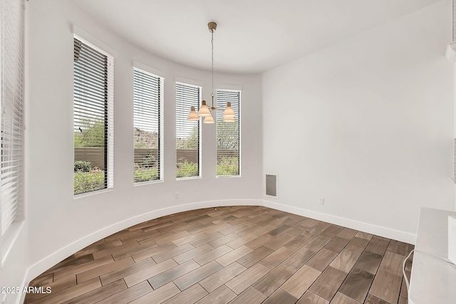 9017 E June Cir, Mesa, AZ 85207 - unfurnished dining area with dark wood-style flooring, baseboards, and a chandelier