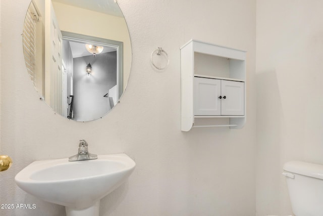 bathroom featuring toilet and a sink