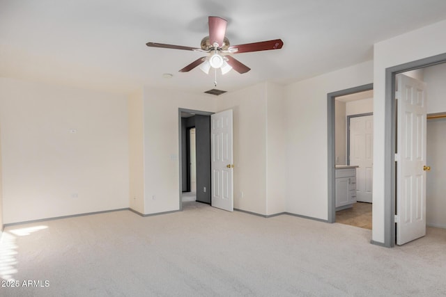 unfurnished bedroom featuring light carpet, visible vents, ensuite bath, and baseboards