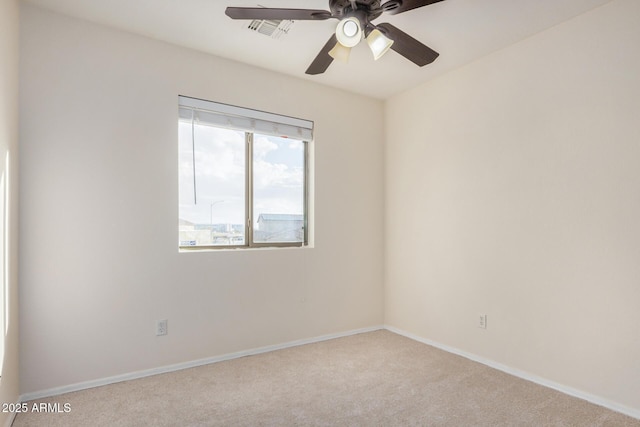 unfurnished room with visible vents, baseboards, carpet, and a ceiling fan