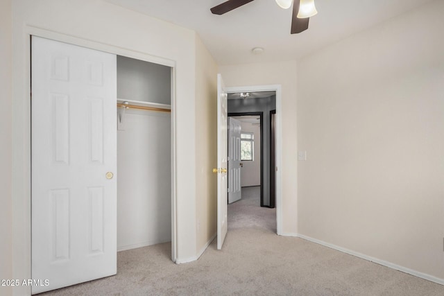 unfurnished bedroom with a ceiling fan, baseboards, a closet, and carpet floors