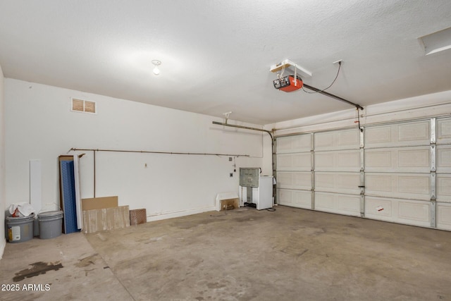 garage featuring visible vents and a garage door opener