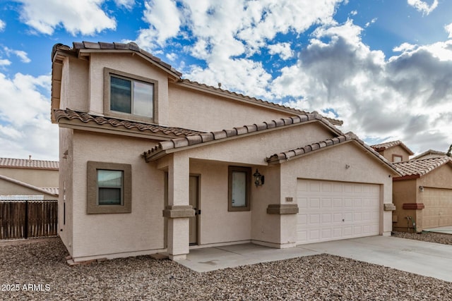 view of front of property featuring concrete driveway, an attached garage, fence, and stucco siding