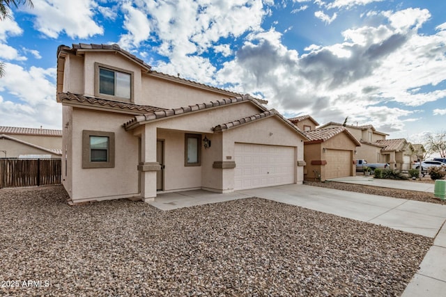 mediterranean / spanish-style home with fence, a tiled roof, concrete driveway, stucco siding, and an attached garage