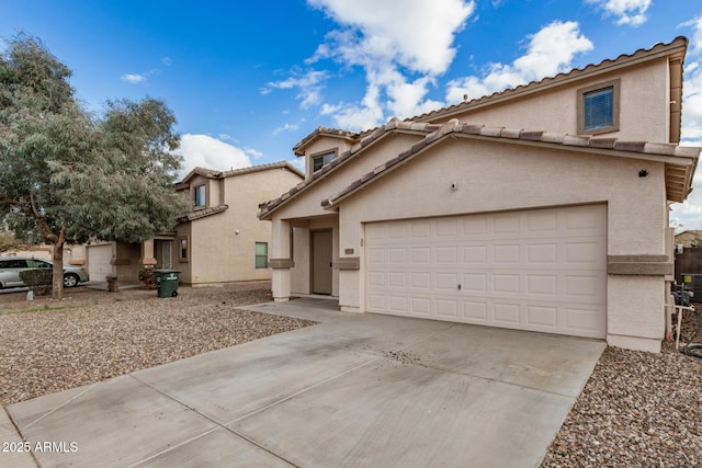 mediterranean / spanish house featuring a tiled roof, stucco siding, driveway, and a garage