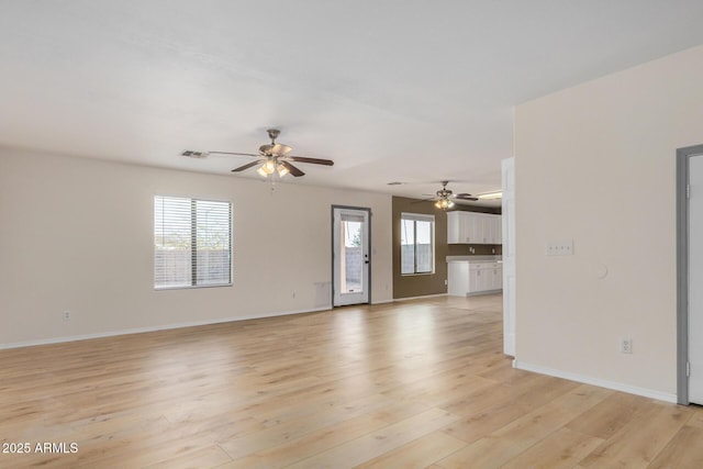 unfurnished living room featuring ceiling fan, visible vents, baseboards, and light wood-style flooring