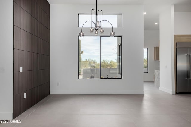 unfurnished dining area featuring a notable chandelier and light tile patterned flooring