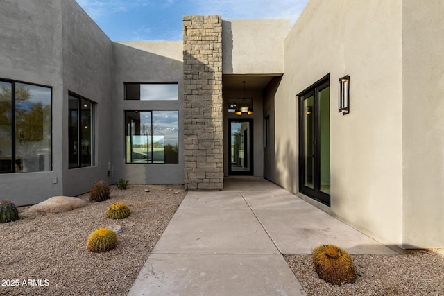 property entrance featuring a patio