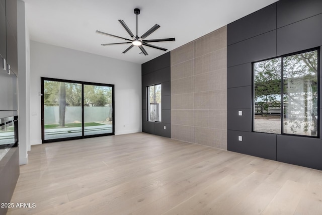 unfurnished room featuring ceiling fan and light wood-type flooring