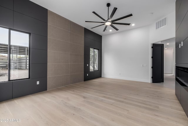 interior space with ceiling fan and light wood-type flooring