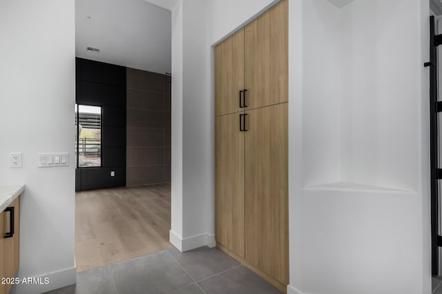 corridor with light tile patterned flooring