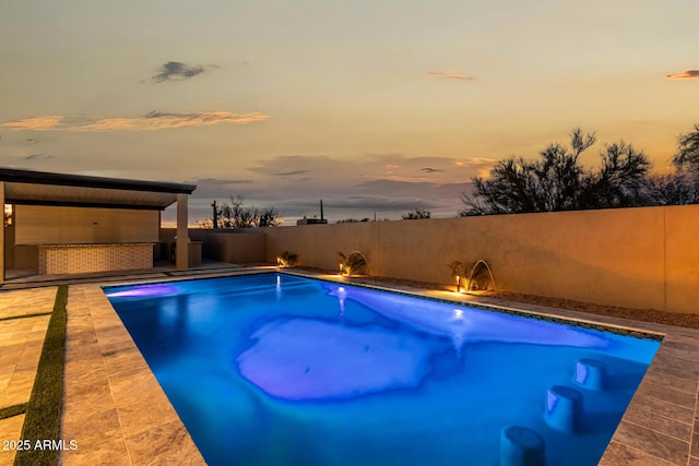 view of pool at dusk