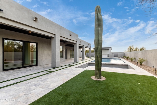 view of yard with a fenced in pool and a patio