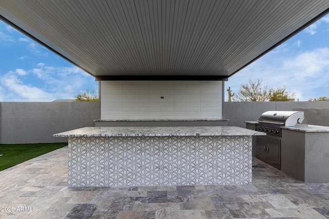 view of patio featuring exterior kitchen and area for grilling