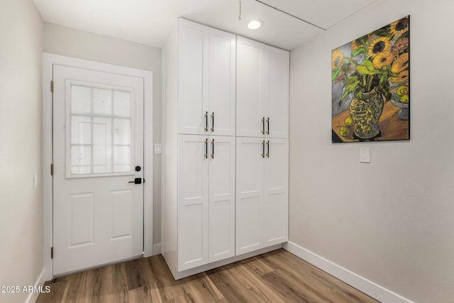 interior space featuring light wood-style floors and baseboards