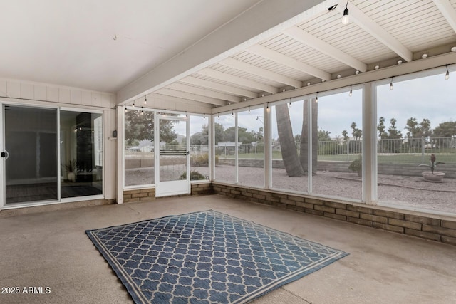 sunroom / solarium featuring a wealth of natural light and beam ceiling