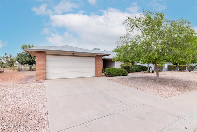 ranch-style house with brick siding, driveway, and an attached garage