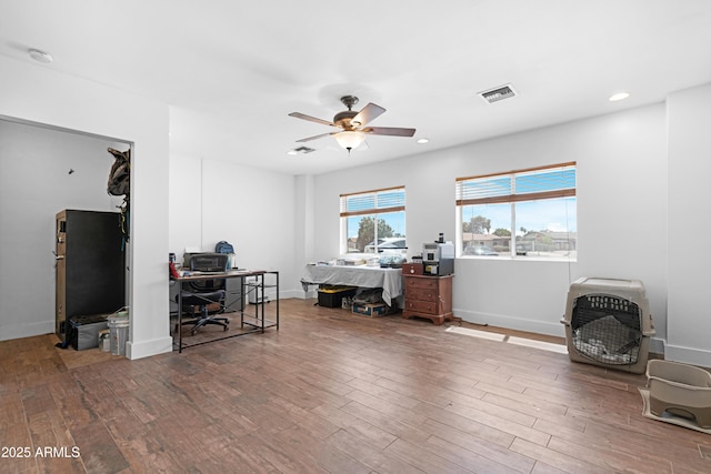office featuring ceiling fan, visible vents, wood finished floors, baseboards, and recessed lighting
