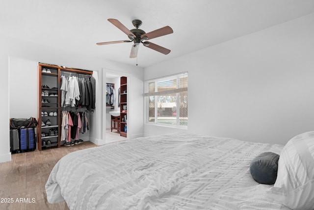 bedroom featuring baseboards, ceiling fan, and wood finished floors