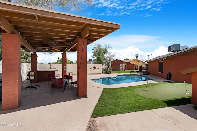 view of swimming pool featuring a ceiling fan, a fenced in pool, cooling unit, a fenced backyard, and a patio