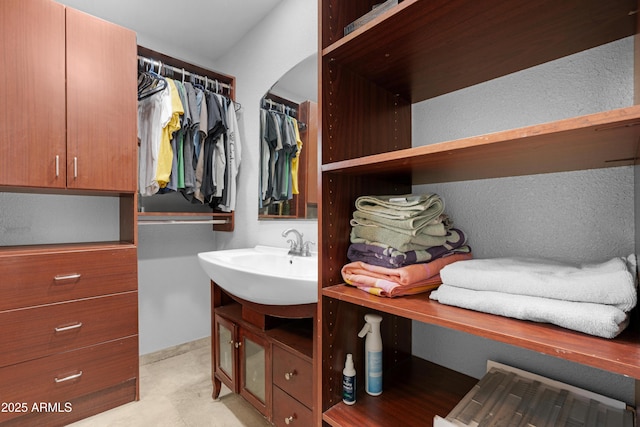walk in closet featuring a sink
