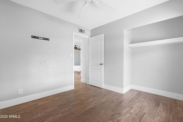 unfurnished room with baseboards, ceiling fan, wood finished floors, and visible vents