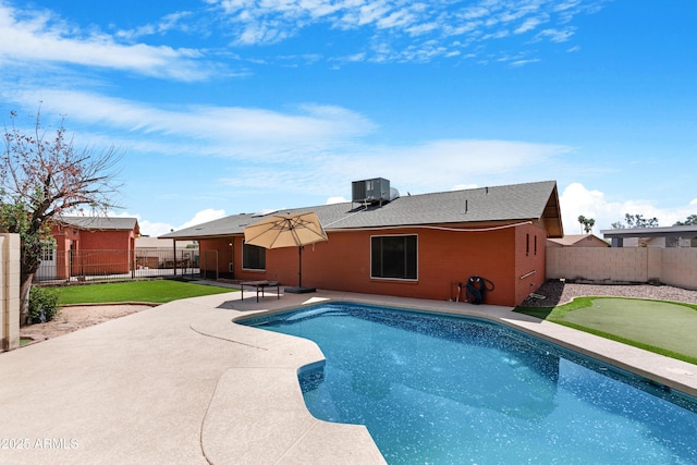 view of swimming pool featuring a patio, a fenced in pool, central AC unit, and a fenced backyard