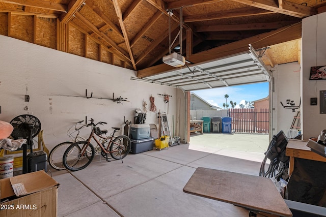 garage with a garage door opener and electric panel