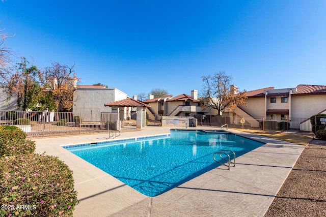 pool featuring a residential view, fence, a gazebo, and a patio