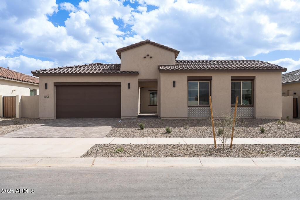 829 W Golden Ore Pass, Apache Junction, AZ 85120 - mediterranean / spanish home featuring driveway, stucco siding, a tiled roof, and a garage