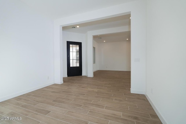 empty room featuring recessed lighting, baseboards, and wood finish floors