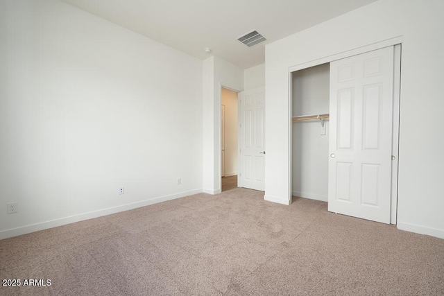 unfurnished bedroom with a closet, visible vents, baseboards, and carpet