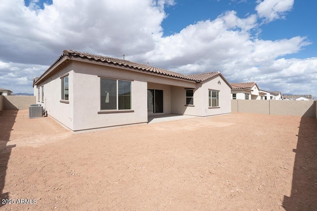 back of property with central AC unit, a patio, a fenced backyard, and stucco siding