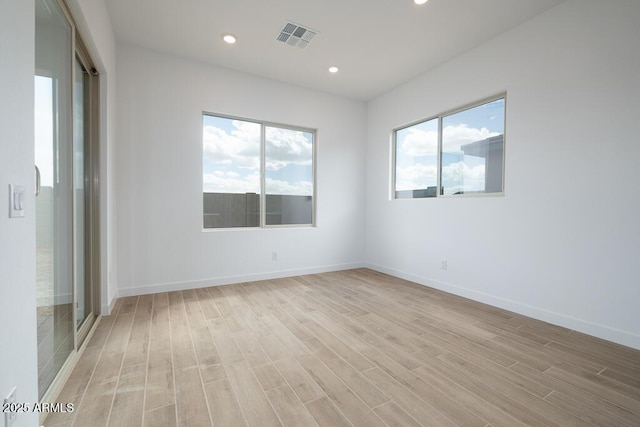 empty room with recessed lighting, visible vents, baseboards, and light wood-style floors