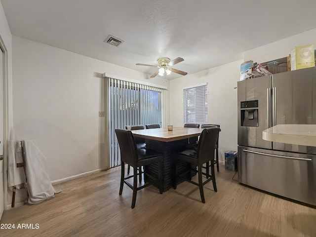 dining area featuring ceiling fan and light hardwood / wood-style flooring