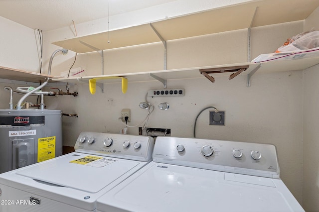 clothes washing area with laundry area, washing machine and dryer, and electric water heater