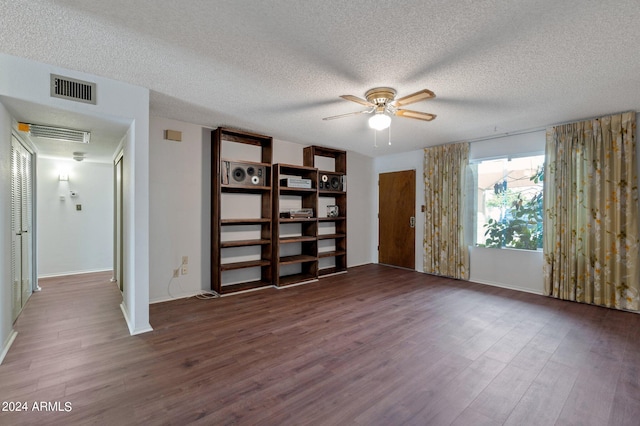 spare room with ceiling fan, a textured ceiling, visible vents, and wood finished floors