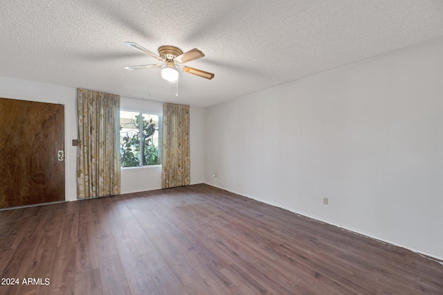 unfurnished room with dark wood-type flooring, a textured ceiling, and a ceiling fan