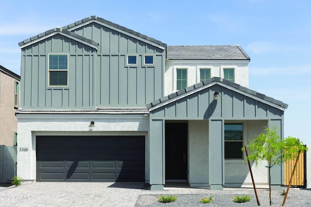 view of front of property featuring board and batten siding, driveway, and an attached garage