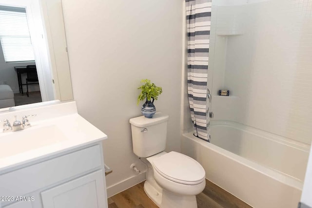 bathroom with shower / bathtub combination with curtain, toilet, vanity, wood finished floors, and baseboards