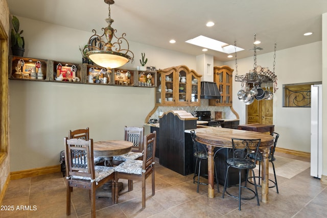 21909 W Beacon Ln, Wittmann, AZ 85361 - tiled dining room featuring a skylight, baseboards, and recessed lighting