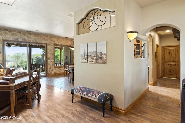 21909 W Beacon Ln, Wittmann, AZ 85361 - hallway with baseboards, arched walkways, and wood finished floors