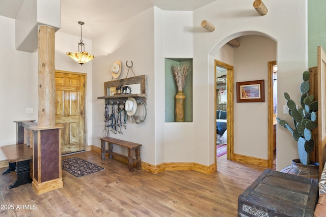 21909 W Beacon Ln, Wittmann, AZ 85361 - entrance foyer with arched walkways, baseboards, and wood finished floors